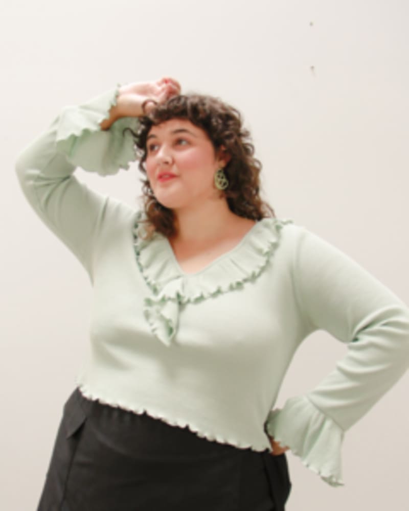 Side of a model wearing a size L Dazed Ruffled Top in Aloe by Lovefool. | dia_product_style_image_id:249535